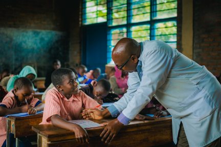 Esther and her teacher in school 