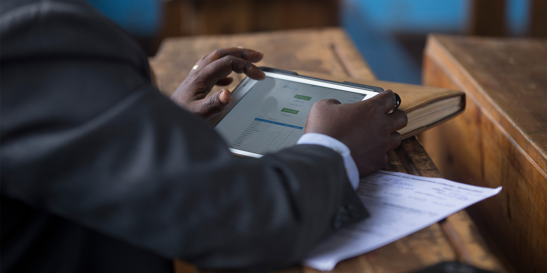 Wellspring trainer inputting information into MERIT, our monitoring and evaluation technology.